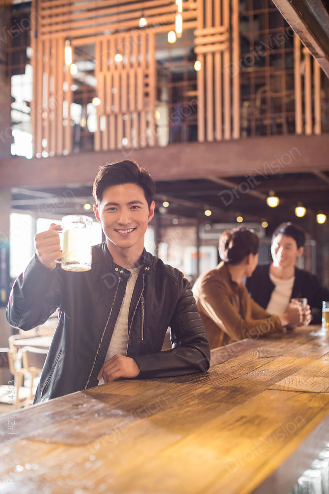 快乐的年轻男士在酒吧喝酒图片