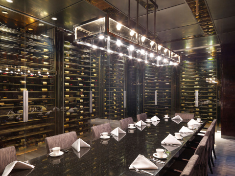Lit hanging light over chairs and set table at an elegant restaurant