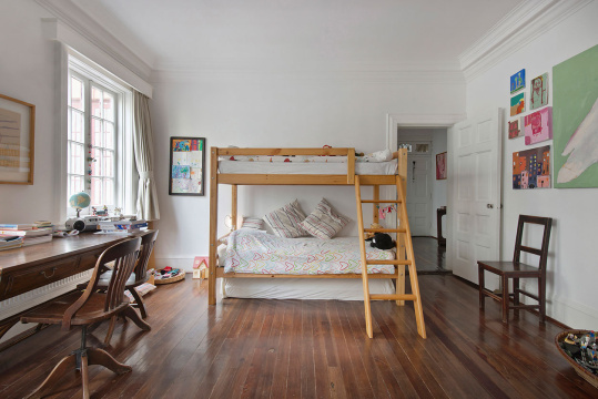 Spacious kid's room with bunk bed and study desk at home