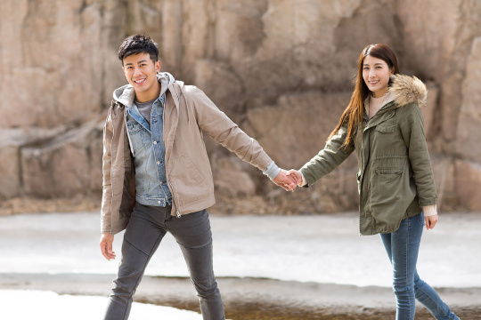 Happy young Chinese couple enjoying winter outing