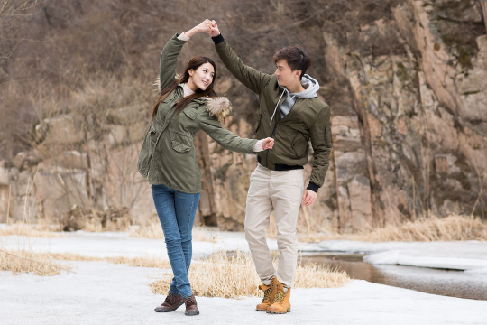 Happy young Chinese couple enjoying winter outing