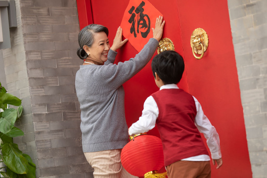 快乐的祖孙俩贴福字迎新年