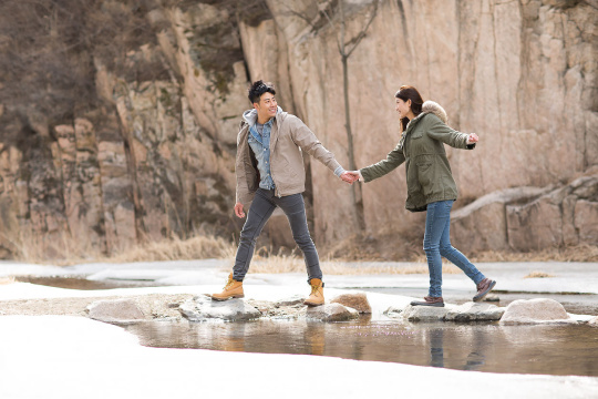 Happy young Chinese couple enjoying winter outing