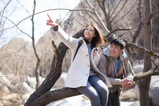 Happy young Chinese couple enjoying winter outing