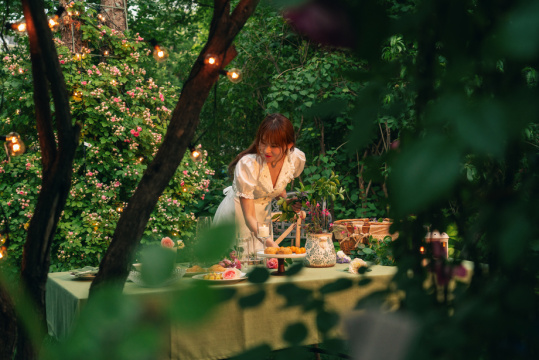 年轻美女在庭院里准备晚餐