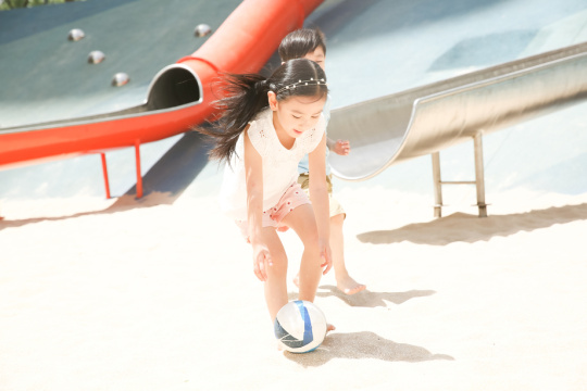 儿童在沙子里踢球