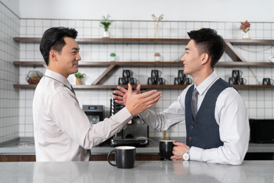 同事在茶水间边喝咖啡边相互鼓励