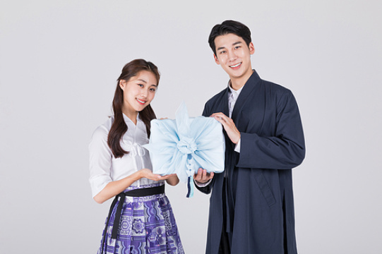 秋夕购物_一对夫妇拿着一个传统盒子的照片图像 