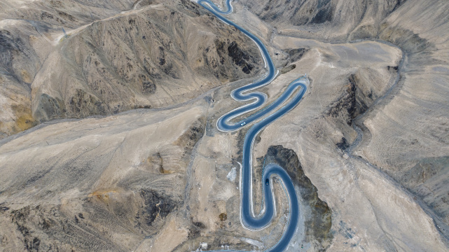 汽车行驶在蜿蜒的山路上新疆盘龙古道