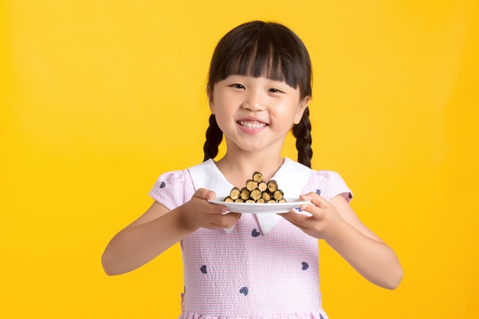 吃海苔肉松卷的亚洲小女孩棚拍半身肖像